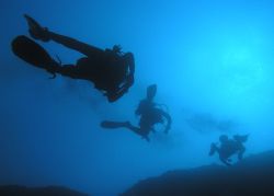 3 Divers in the cristal clear sea near Dubrovnik. by Eugen Miljan 